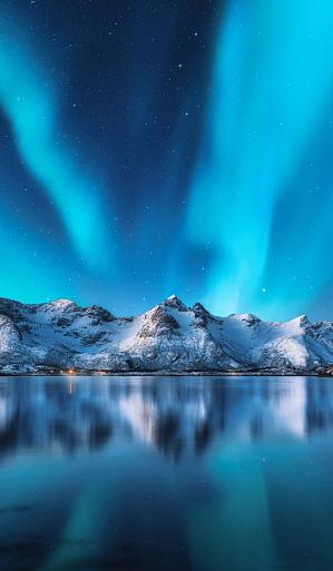 Besneeuwde bergen met Noorderlicht op de Lofoten-eilanden, Noorwegen