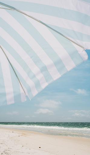 Blauw witte parasol op het strand